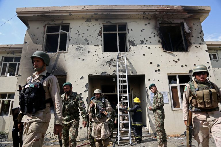 Afghan security personal surround the area after Taliban fighters stormed a government building in Jalalabad, east of Kabul, Afghanistan, Monday, May 12, 2014. Taliban fighters stormed a government building in eastern Afghanistan killing police guards on Monday, the most serious in a wave of attacks marking the start of the insurgents' annual spring offensive. In the Taliban heartland in the south, an attack on a police checkpoint in Helmand province killed many policemen. (AP Photo/Rahmat Gul)