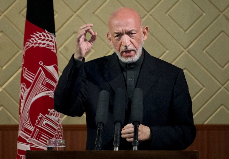 Afghan President Hamid Karzai gestures during a ceremony at Kabul University in Kabul, Afghanistan, Thursday, May 9, 2013. Karzai said he is ready to let the U.S. have nine bases in the country after the 2014 combat troop pullout, but wants Washington's 
