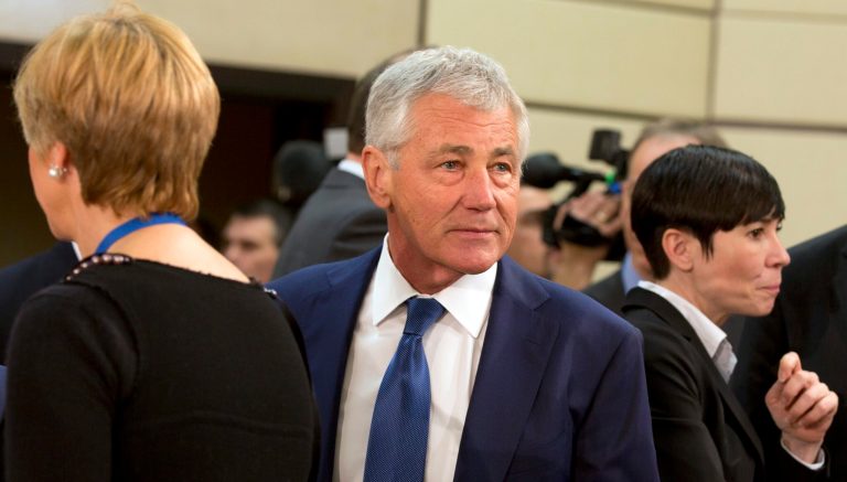 U.S. Secretary of Defense Chuck Hagel, center, arrives for a meeting of defense ministers of the North Atlantic Council at NATO headquarters in Brussels on Wednesday, Feb. 26, 2014. Frustrated with his Afghan counterpart, U.S. President Barack Obama is ordering the Pentagon to accelerate planning for a full U.S. troop withdrawal from Afghanistan by the end of this year. But Obama is also holding out hope that Afghanistan's next president may eventually sign a stalled security agreement that could prevent the U.S. from having to take that step. (AP Photo/Virginia Mayo)
