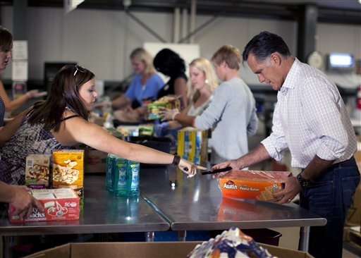 Republican presidential candidate, former Massachusetts Gov. Mitt Romney helps a group of volunteers at the Care and Share Food Bank of Southern Colorado prepare food for distribution to those affected by the wildfires on Tuesday, July 10, 2012 in Colorado Springs, Colo. (AP Photo/Evan Vucci)