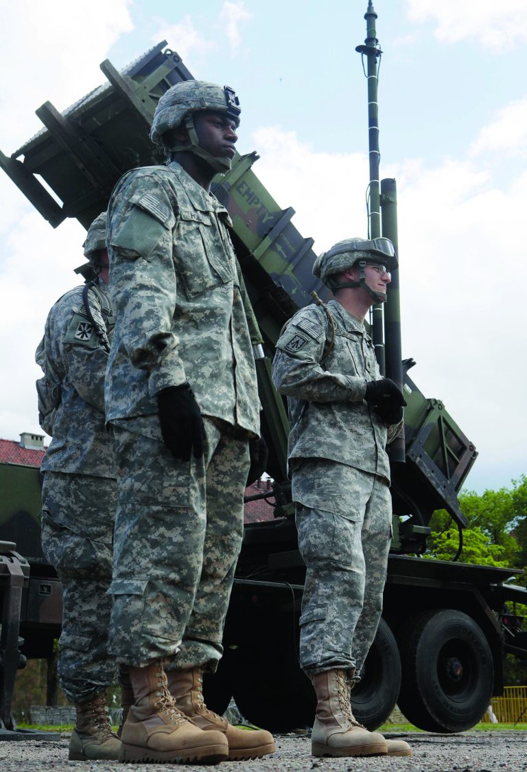 FILE - In this May 26, 2010 file photo, a U.S. soldier stands next to a Patriot surface-to-air missile battery at an army base in Morag, Poland. Turkey's government requested the deployment of NATO's Patriot surface-to-air missiles on Wednesday, Nov. 21, 2012 to bolster its defenses along its border with Syria and prevent a spillover of the civil war in that nation, officials said. (AP Photo/Czarek Sokolowski, File)