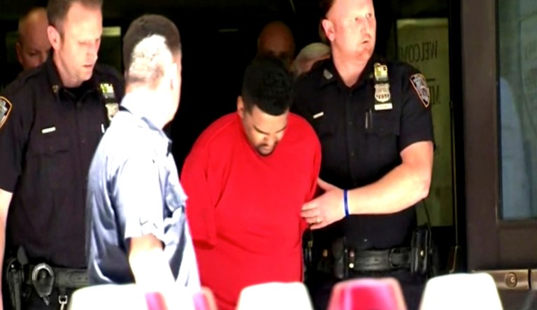 New York City Police officers escort Richard Rojas from the Midtown South Precinct station house in New York. Rojas steered his car onto a sidewalk running through the heart of Times Square on Thursday and mowed down pedestrians for three blocks, killing a teenager and injuring 22 others, before he was tackled by bystanders, authorities said. (WABC Eyewitness News via AP)