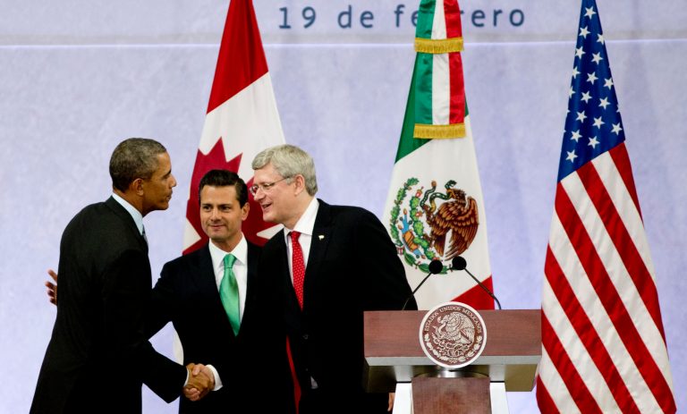 President Barack Obama, left, Mexico's President Enrique Pena Nieto, center, and the Prime Minister of Canada, Stephen Harper, shake hands at the end of a news conference in Toluca, Mexico, Wednesday, Feb. 19, 2014. (AP Photo)Â 