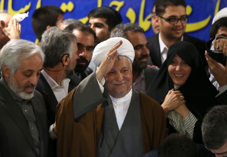 Former President Akbar Hashemi Rafsanjani waves to reporters, as he registers his candidacy for the upcoming presidential election, at the election headquarters of the interior ministry in Tehran, Iran, Saturday, May 11, 2013. Iranian election authorities say several new high-profile politicians including hardliners, reformists, and allies of outgoing President Mahmoud Ahmadinejad have registered for the June 14 presidential elections. The campaign is taking shape as open season on Ahmadinejad's legacy and his combative style that bolstered his stature among supporters but alarmed critics. Ahmadinejad is barred by law from seeking a third term due to term limits under Iran's constitution. (AP Photo/Ebrahim Noroozi)