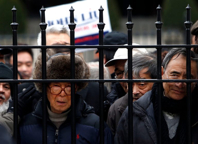 Supporters wait to be allowed onto City Hall grounds before the launch of New York City Comptroller John Liu's mayoral campaign on the steps of City Hall, Sunday, March 17, 2013 in New York. Already the first person of Asian descent to be elected citywide in New York, Liu hopes to become the city's first Asian-American mayor. (AP Photo/Jason DeCrow)