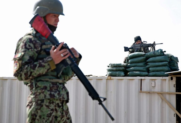 Afghan National Army (ANA) soldiers guard near the main gate of the Parwan Detention Facility Center on the outskirts of Bagram, some 50 kilometers (30 miles) north of Kabul, Afghanistan, Thursday, Feb. 13, 2014. Afghanistan released 65 accused militants from a former U.S. prison on Thursday despite protests from the American military, which says the men are Taliban fighters who will likely return to the battlefield to kill coalition and Afghan forces. (AP Photo/Massoud Hossaini)