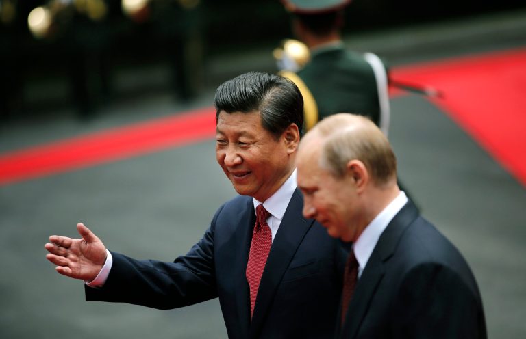 Russia's President Vladimir Putin, right, and China's President Xi Jinping review an honor guard during a welcome ceremony at the Xijiao State Guesthouse ahead of the fourth Conference on Interaction and Confidence Building Measures in Asia (CICA) summit, in Shanghai, China, Tuesday, May 20, 2014. (AP Photo/Carlos Barria, Pool)