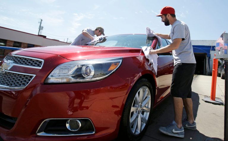 This Friday, June 6, 2014 photo shows David Barry, left, and Anthony Scharf drying a car at a car wash in Woodmere Village, Ohio. The Institute for Supply Management, a trade group of purchasing managers, issues its index of non-manufacturing activity for June on Thursday, July 3, 2014. (AP Photo/Tony Dejak)