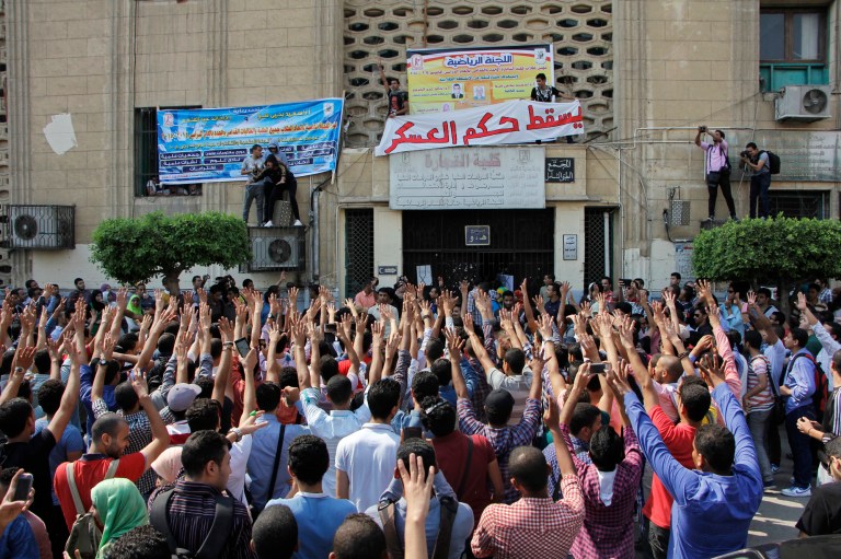Student protesters hold a rally at Cairo University in Cairo, Egypt, Sunday, Oct. 12, 2014. Security officials said police backed by armored vehicles have stormed the campuses of at least two prominent Egyptian universities to quell anti-government protests by students. Sunday's largest rallies took place at Cairo and the Islamist al-Azhar universities. They were organized by supporters of ousted Islamist President Mohammed Morsi. (AP Photo/El Shorouk, Aly Hazzaa) EGYPT OUT
