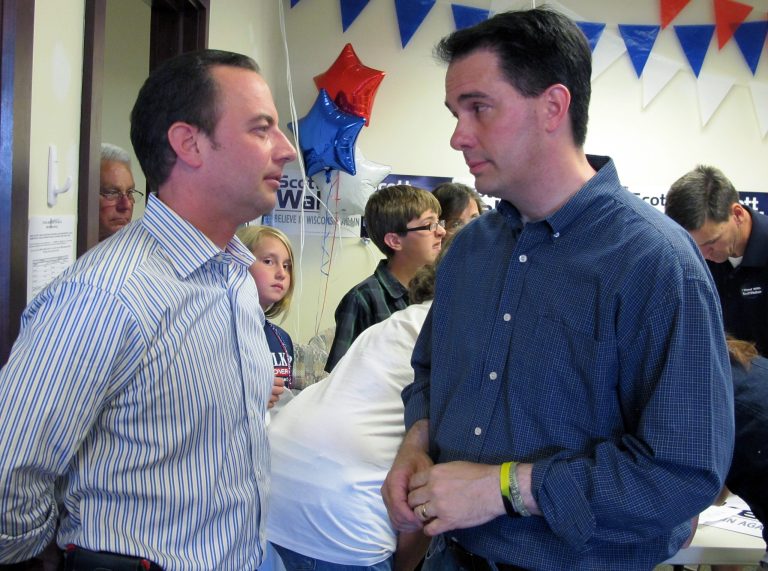   Wisconsin Gov. Scott Walker, right, talks with Republican National Committee Chairman Reince Priebus at a Republican campaign office in Germantown, Wis., on Sunday, June 3, 2012. Walker and Priebus were rallying volunteers ahead of a recall election for Walker on Tuesday. (AP Photo/Dinesh Ramde)  