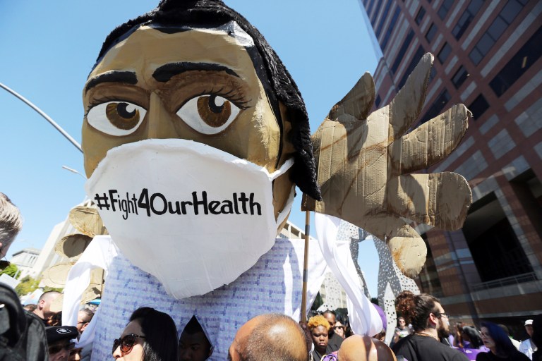 We neglect to ask why our cell phones grow cheaper while our healthcare grows more expensive. (AP Photo/Reed Saxon)