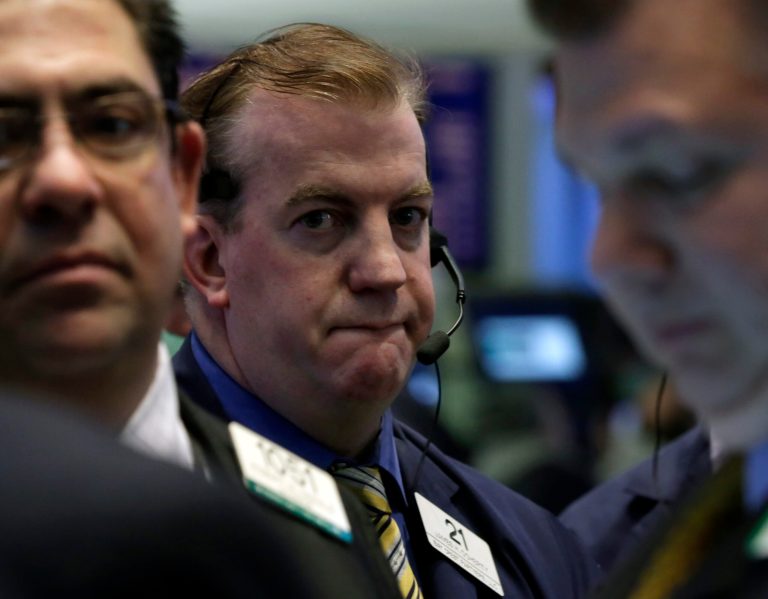 FILE - In this  Friday, Jan. 31, 2014, file photo, traders work on the floor of the New York Stock Exchange. Shares were lackluster Wednesday Feb. 19, 2014 as investors waited for major earnings reports and took stock of a torrid start to the year for global markets. (AP Photo/Richard Drew, File)