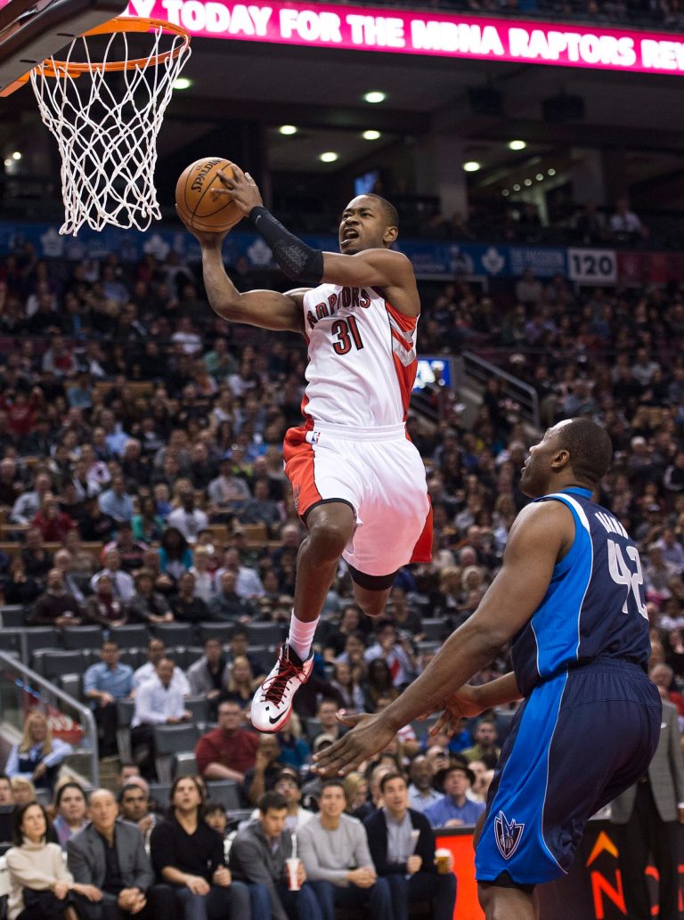   Toronto Raptors forward Terrence Ross, left, slam dunks the ball past Dallas Mavericks Elton Brand, right, during first half NBA basketball action in Toronto on Friday, Dec. 14, 2012. (AP Photo/The Canadian Press, Nathan Denette)  
