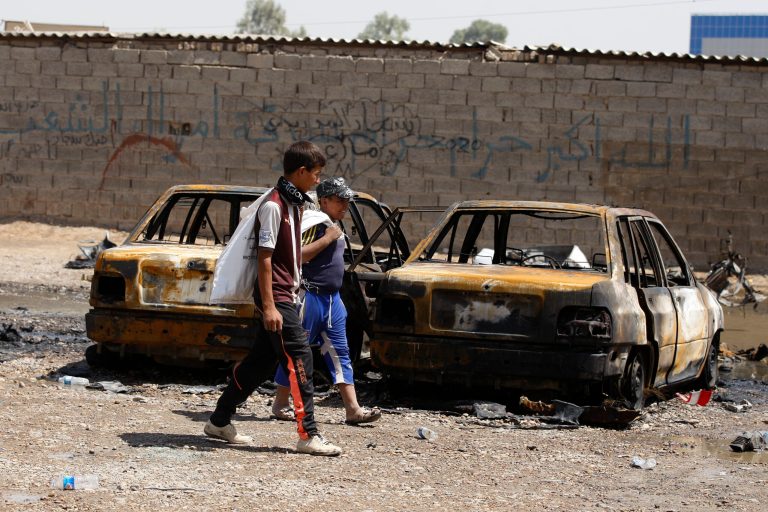   Children inspect the aftermath of a car bomb attack in Baghdad, Iraq, Thursday, Aug. 15, 2013. A wave of car bombs in the Iraqi capital on Wednesday killed and wounded dozens of people, the latest attacks in a months-long surge in violence. More than 3,000 people have been killed in violence during the past few months, raising fears Iraq could see a new round of widespread sectarian bloodshed similar to that which brought the country to the edge of civil war in 2006 and 2007. (AP Photo/Karim Kadim)  