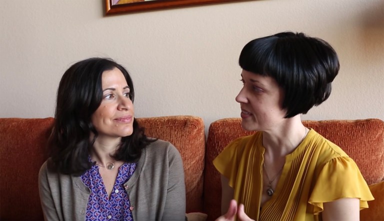 A lawsuit, filed by the LGBTQ legal group Lambda Legal, says that married couple Fatma Marouf (pictured left) and Bryn Esplin (pictured right) tried to become foster parents for refugee children. It was filed against the Department of Health and Human Services and the U.S. Conference of Catholic Bishops. (Screenshot / Lambda Legal via YouTube)