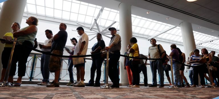 People wait in line to sign up for unemployment Wednesday, Sept. 3, 2014, in Atlantic City, N.J. Thousands of newly laid-off casino workers turned out at the Atlantic City Convention Center for a mass unemployment filing. The session Wednesday morning comes after a brutal weekend that saw more than 5,000 employees at the Showboat and Revel lose their jobs. (AP Photo/Mel Evans)