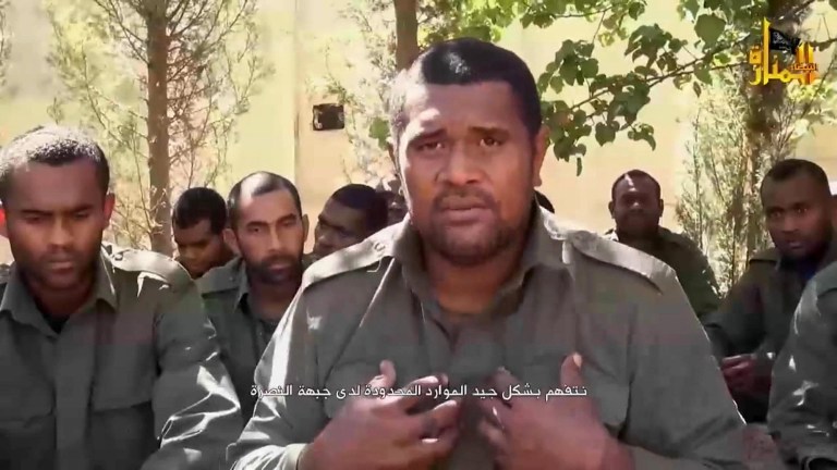 This image made from video posted on a militant social media account on Thursday, Sept. 11, 2014 shows U.N. peacekeepers from Fiji held captive by militants from the Nusra Front in Syria. The 45 Fijian peacekeepers held captive by an al-Qaida-linked Syrian rebel group are alive and well and will be released soon, one of the hostages said in a video released Thursday by the militants. Fighters from the Nusra Front captured the Fijian troops late last month in the Golan Heights, where a 1,200-strong U.N. force monitors the buffer zone between Syria and Israel. Arabic reads, 