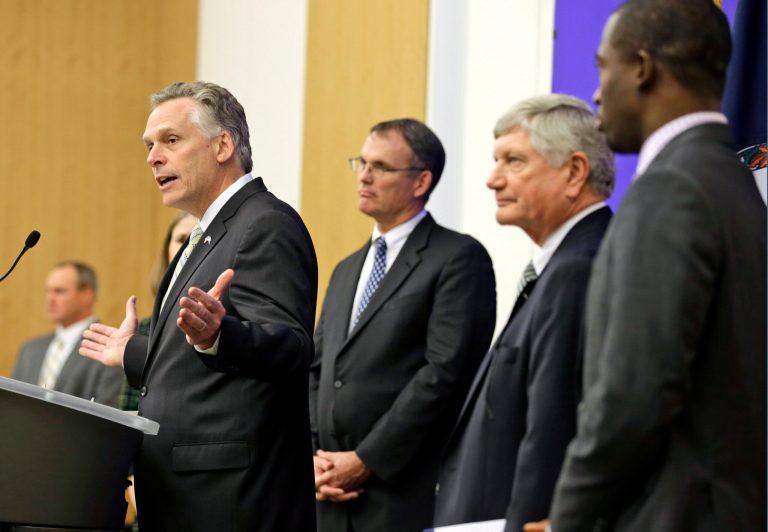 Virginia Gov-elect Terry McAuliffe, left at podium, gestures during a news conference where he announced Levar Stoney, far right, as Secretary of the Commonwealth. (AP Photo/Steve Helber)
