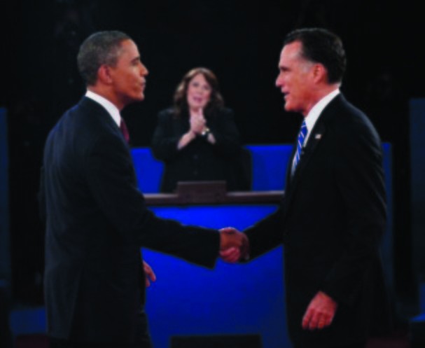 Moderator Candy Crowley, center, applauds as President Barack Obama, left, shakes hands with Republican presidential nominee Mitt Romney during the second presidential debate at Hofstra University, Tuesday, Oct. 16, 2012, in Hempstead, N.Y. (AP Photo/Michael Reynolds, Pool)