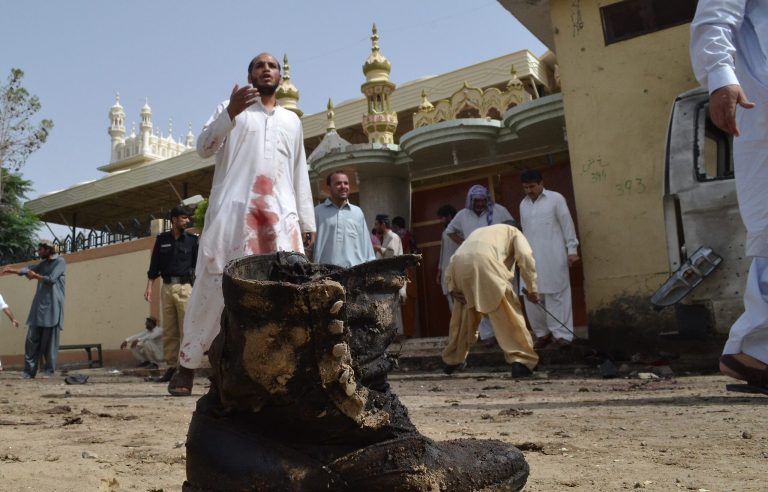   Pakistani investigators collect evidence at the site of a bomb attack in Quetta, Pakistan, Thursday, Aug. 8, 2013. A suicide bomber attacked a funeral for a policeman in southwestern Pakistan on Thursday, killing tens of people, including a senior police officer, and wounding over 60, police said. (AP Photo/Arshad Butt)  