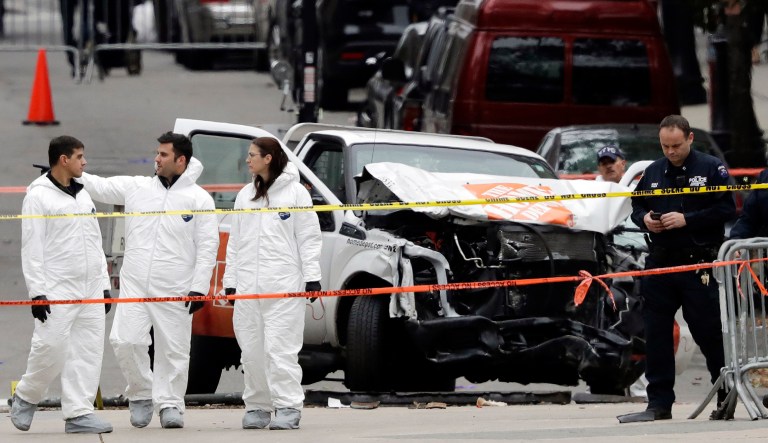 Law enforcement personnel examine the scene after a driver mowed down people on a riverfront bike path near the World Trade Center on Tuesday in New York. (AP Photo/Mark Lennihan)