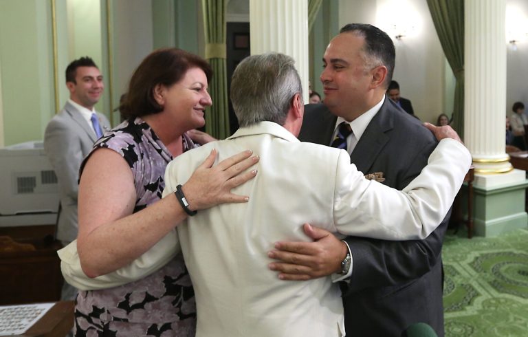 Assemblyman Tom Ammiano, D-San Francisco, center, is congratulated by Assembly Speaker Toni Atkins, D-San Diego, and Assemblyman John Perez, D-Los Angeles, after his measure to thwart or reverse wrongful criminal convictions was approved by the Assembly at the Capitol in Sacramento, Calif., Friday, Aug. 29, 2014.   Ammianno's bill, AB885, which would allow juries in criminal cases to consider whether prosecutors intentionally withheld evidence when deliberating a verdict.AP Photo/Rich Pedroncelli)