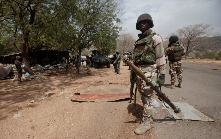 In this file photo taken Wednesday, April 8, 2015, Nigerian soldiers man a check point in Gwoza, Nigeria, a town newly liberated from Boko Haram. (AP Photo/Lekan Oyekanmi,File)