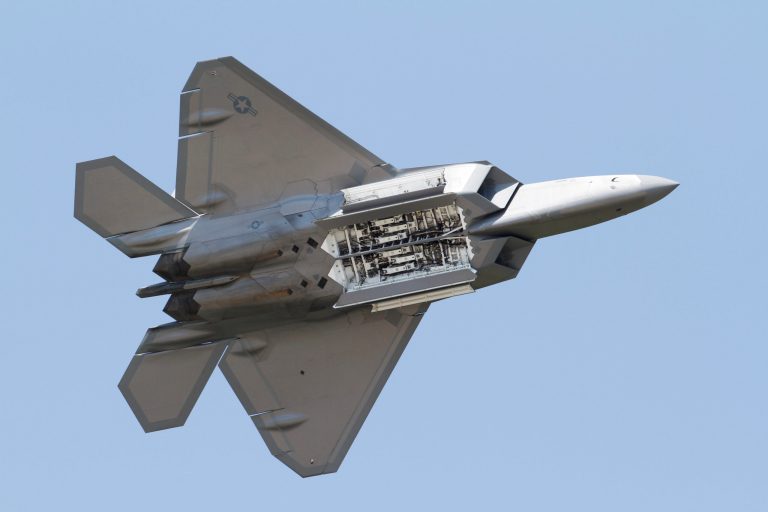 FILE - In this Monday April 30, 2012 file photo, an Air Force F-22 Raptor displays it's weapons bays during maneuvers at a demonstration at Langley Air Force Base in Hampton, Va.  The Air Force is thrilled to have its F-22 Demonstration Team beginning the heart of its summer airshow schedule after being cancelled altogether last year due to sequestration. (AP Photo/Steve Helber)