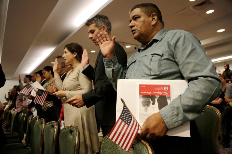 New United States citizens recite the Oath of Allegiance while participating in a naturalization ceremony, Wednesday, July 9, 2014 in New York. (AP Photo/Mark Lennihan)