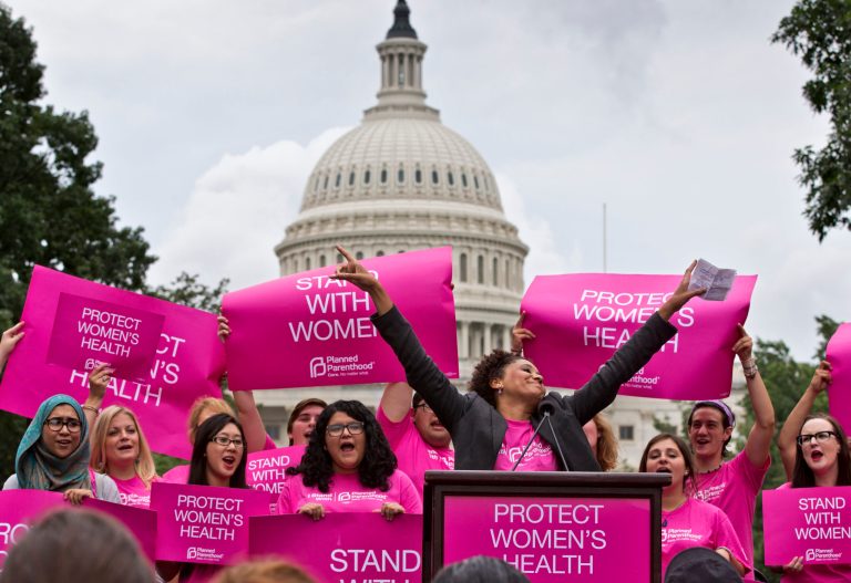 Cheered on by Carol McDonald from Planned Parenthood Federation of America, women rally on Capitol Hill in Washington, Thursday, July 11, 2013, to oppose legislation that would limit legal abortion. (AP Photo/J. Scott Applewhite)