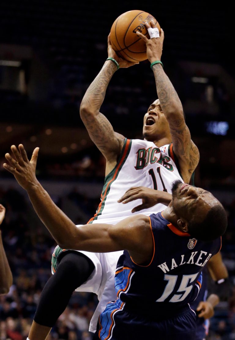   Milwaukee Bucks' Monta Ellis (11) is fouled as he shoots over Charlotte Bobcats' Kemba Walker (15) during the second half of an NBA basketball game, Friday, Dec. 7, 2012, in Milwaukee. (AP Photo/Morry Gash)  