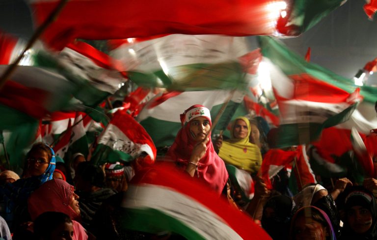 Women supporters of Pakistan's fiery cleric Tahir-ul-Qadri wave party flags as they take part in an anti government rally in Lahore, Pakistan, Sunday, Oct. 19, 2014. Thousands of anti-government protestors  led Muslim cleric Tahir-ul-Qadri rallied in Lahore demanding Prime Minister Nawaz Sharif's ouster over alleged fraud in last year's election. (AP Photo/K.M. Chaudary) (AP Photo/K.M. Chaudary)