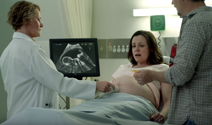 The question every Democrat must answer: When does life begin? The Doritos ad depicts a woman being shown an ultrasound of her unborn baby for the first time. Meanwhile, her husband is eating a bag of Doritos and notices that the baby is responding to his hand motions, in an attempt to grab a chip. (Photo courtesy of screen shot)