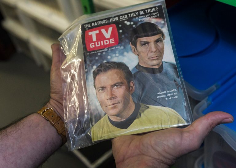   In this Friday, Nov. 30, 2012 photo, James Comisar holds an original TV Guide issue featuring William Shatner, and Leonard Nimoy of 