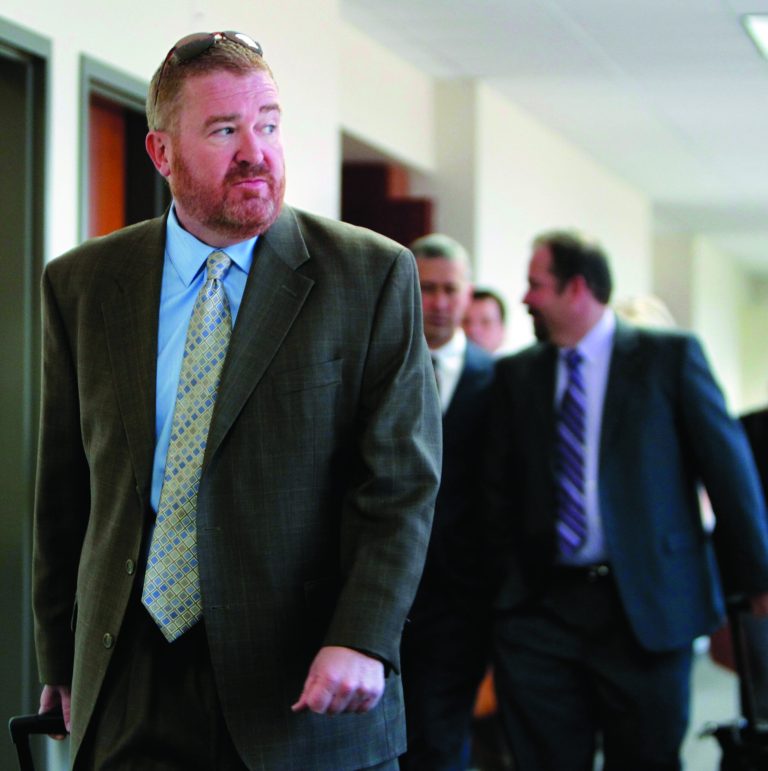Defense Attorney Daniel King, left, leads the defense team out of the courtroom after a hearing for suspected theater shooter James Holmes in district court in Centennial, Colo., on Thursday, Sept. 20, 2012. Holmes has been charged in the shooting at the Aurora theater on July 20 that killed twelve people and injured more than 50. (AP Photo/Ed Andrieski)