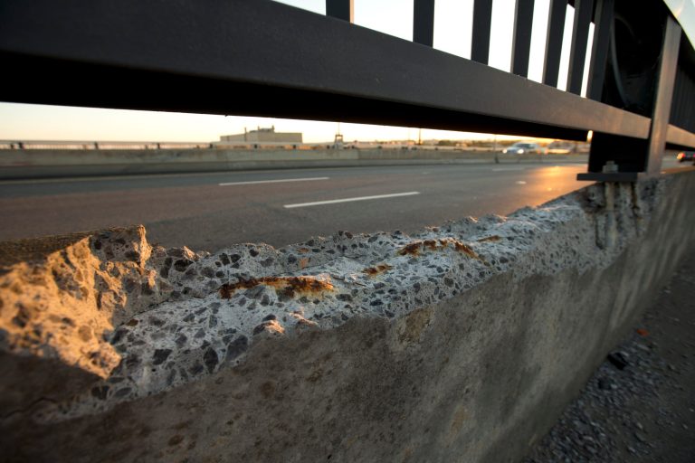   Cracked concrete exposes parts of reinforcement bars on the Frederick Douglass Memorial Bridge which spans the Anacostia River in Washington on Wednesday, Sept. 4, 2013. The bridge, which carries more than 70,000 vehicles a day, was designed to last 50 years. Itâs now 13 years past its life expectancy. An Associated Press analysis of 607,380 bridges in the most recent federal National Bridge Inventory showed that 65,605 were classified as 