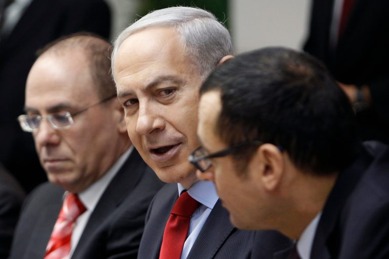   Israeli Prime Minister Benjamin Netanyahu, center, attends the weekly cabinet meeting in his Jerusalem office, Sunday, Dec. 9, 2012. (AP Photo/Ammar Awad, Pool)  