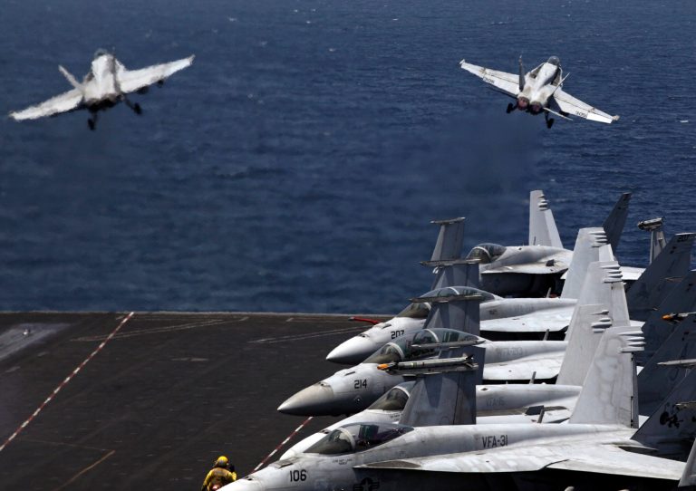 U.S. F/A-18 fighter jets take off for mission in Iraq from the flight deck of the U.S. Navy aircraft carrier USS George H.W. Bush, in the Persian Gulf, Monday, Aug. 11, 2014. U.S. military officials said American fighter aircraft struck and destroyed several vehicles Sunday that were part of an Islamic State group convoy moving to attack Kurdish forces defending the northeastern Iraqi city of Irbil. (AP Photo/Hasan Jamali)