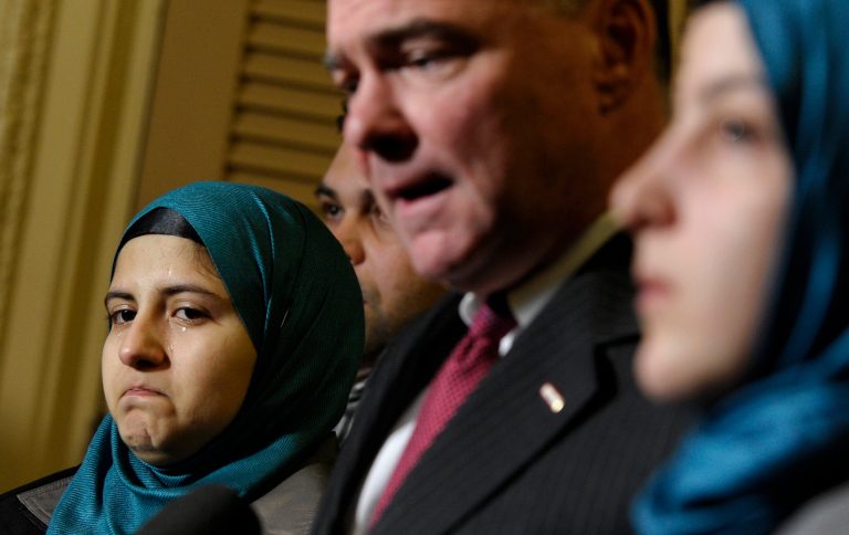 Sen. Tim Kaine, D-Va., chairman of the Senate Foreign Relations subcommittee on Near Eastern, Southern and Central Asian Affairs, second from right, speaks as Heba Sawan, left, tears up during a news conference with sister Amineh Sawan, right, and Anas al-Dabas, second from left, on Capitol Hill in Washington, Thursday, Feb. 6, 2014. The Sawan sisters were survivors of the August 2013 chemical weapons attack in Moadamiya, Syria that left more than 1,200 Syrians dead and many more wounded. Al-Dabas witnessed the 2012 massacre in Daraya that took the lives of 540 Syrians.  (AP Photo/Susan Walsh)