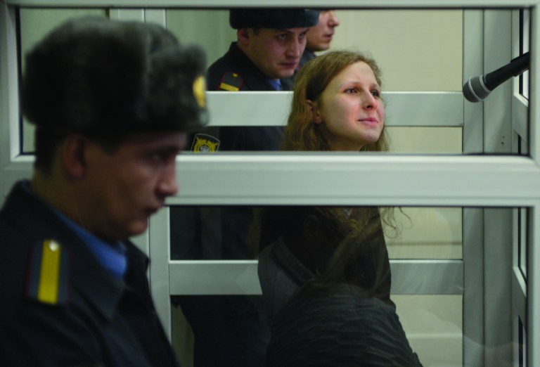 Jailed feminist punk band Pussy Riot member Maria Alekhina is seen in a cell at a court room in the town of Berezniki, some 1500 km (940 miles) north-east of Moscow, Russia, on Wednesday, Jan. 16, 2013. A Russian court on Wednesday turned down her attempt to defer serving her sentence until her preschool son becomes a teenager. Alekhina was convicted last year along with two other band members of hooliganism motivated by religious hatred for an anti-President Vladimir Putin stunt in Russia's main cathedral. (AP Photo/Alexander Agafonov)