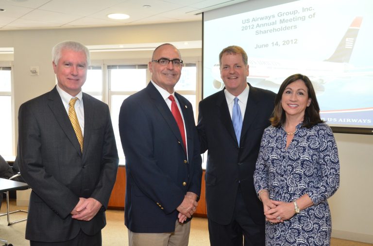   In this Thursday, June 14, 2012, photo provided by U.S. Airways, from left Captain David Bates, APA President, John Conley, International Vice President, Assistant to the International Vice President, Transport Workers Union of America, AFL-CIO, Doug Parker, US Airways Chairman and CEO, and Laura Glading, APFA President attend the US Airwaysâ Shareholder Meeting in support of a merger between US Airways and American Airlines. US Airways Group Inc. CEO Doug Parker told shareholders Thursday that a merger with his airline is the only way American Airlines can reclaim leadership of the industry.(AP Photo/US Airways)  