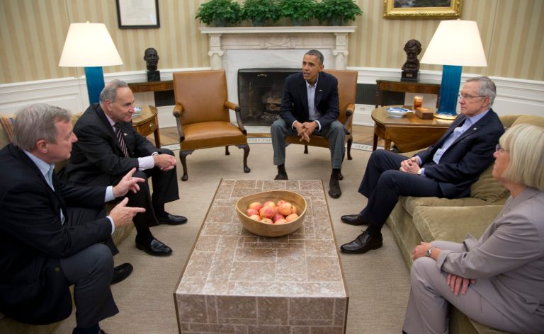 From left, Sen. Dick Durbin, D-Ill., Sen. Charles Schumer, D-N.Y., President Barack Obama, Senate Majority Leader Harry Reid of Nev., Sen. Patty Murray, D-Wash., meet in the Oval Office of the White House, Saturday, Oct. 12, 2013, in Washington. The federal government remains partially shut down and faces a first-ever default between Oct. 17 and the end of the month. (AP Photo/Carolyn Kaster)
