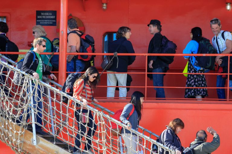 Passengers disembark from the Aurora Australis in Hobart, Australia Wednesday, Jan. 22, 2014, following their rescue from a ship trapped in ice in the Antarctic. The ship rescued 52 passengers with the help of a helicopter from a Chinese ship on Jan. 2, 2014 after the Russian icebreaker Akademik Shokalskiy became trapped in ice-clogged Commonwealth Bay on Christmas Eve 2013.(AP Photo/AAP, Rob Blakers) AUSTRALIA OUT, NEW ZEALAND OUT, PAPUA NEW GUINEA OUT, SOUTH PACIFIC OUT, NO SALES, NO ARCHIVES