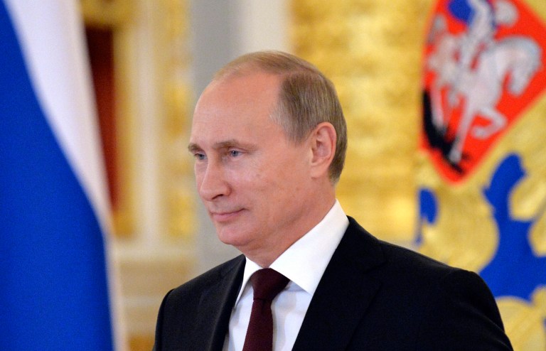 FILE - In this June 27, 2014, file photo, Russian President Vladimir Putin attends  a ceremony of presentation of credentials by foreign ambassadors in the Grand Kremlin Palace in Moscow. In a statement published on the Kremlin website on Friday, July 4, 2014, Putin said 