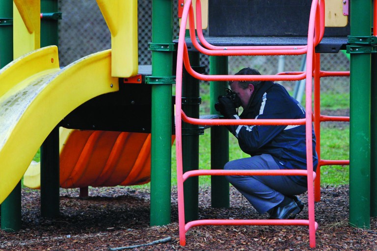 Police investigate the playground in Upper Darby, Pa., where a 5-year-old girl wearing only a T-shirt was found hiding under a piece of playground equipment early Tuesday morning, Jan. 15, 2013. The girl had been abducted Monday morning from the William C. Bryant School, in west Philadelphia, by a woman claiming to be her mother. (AP Photo/Philadelphia Daily News, Alejandro A. Alvarez) THE EVENING BULLETIN OUT, TV OUT; MAGS OUT; NO SALES