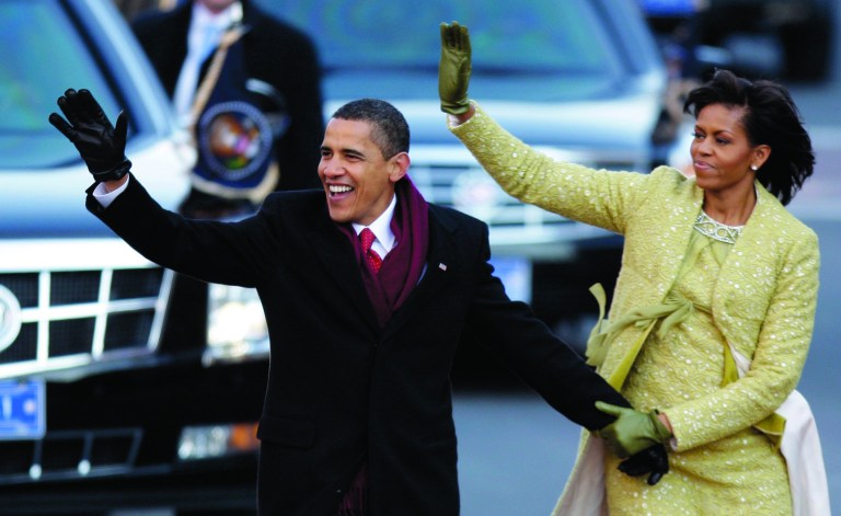 FILE - This Jan. 20, 2009 file photo shows President Barack Obama and first lady Michelle Obama waving as they walk down Pennsylvania Avenue on their way to the White House in Washington, after taking the presidential oath. In a reversal from four years ago, President Barack Obama will accept unlimited sums of money from corporations and individuals to pay for events surrounding his Inauguration, a spokeswoman said Friday. (AP Photo/Alex Brandon, File)