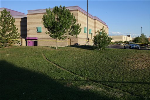 Tire tracks in the grass lead to the back of the Century 16 movie theater Sunday, July 22, 2012, in Aurora, Colo. Twelve people were killed and dozens were injured in a shooting attack early Friday at the packed theater during a showing of the Batman movie, 