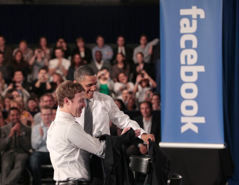 President Obama and Facebook CEO Mark Zuckerberg take off their jackets before the start of their town hall meeting to discuss reducing the national debt, on April 20, 2011. (AP Photo/Pablo Martinez Monsivais)