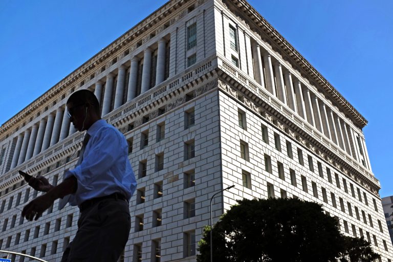 This Oct. 6, 2014 photo a pedestrian walks past the Hall of Justice in downtown Los Angeles. The ornate Los Angeles County Hall of Justice, where Charles Manson and Sirhan Sirhan were tried, has been dedicated in a ceremony on Wednesday, Oct. 8, 2014 marking its reopening after a two-decade closure and a $231 million renovation. (AP Photo/Richard Vogel)
