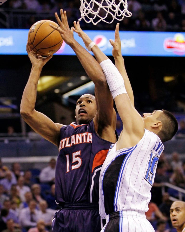   Atlanta Hawks' Al Horford (15) shoots against Orlando Magic's Gustavo Ayon, of Mexico, during the first half of an NBA basketball game, Wednesday Dec. 12, 2012, in Orlando, Fla. (AP Photo/John Raoux)  
